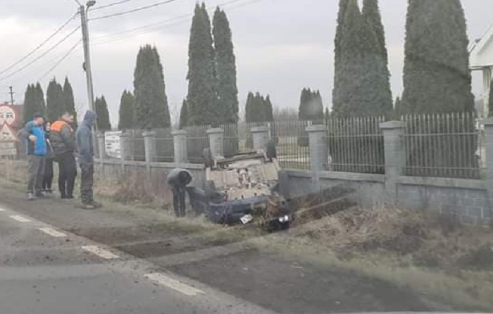 FOTO. Accident în județul Satu Mare. Mașină răsturnată, oprită în gardul unei case